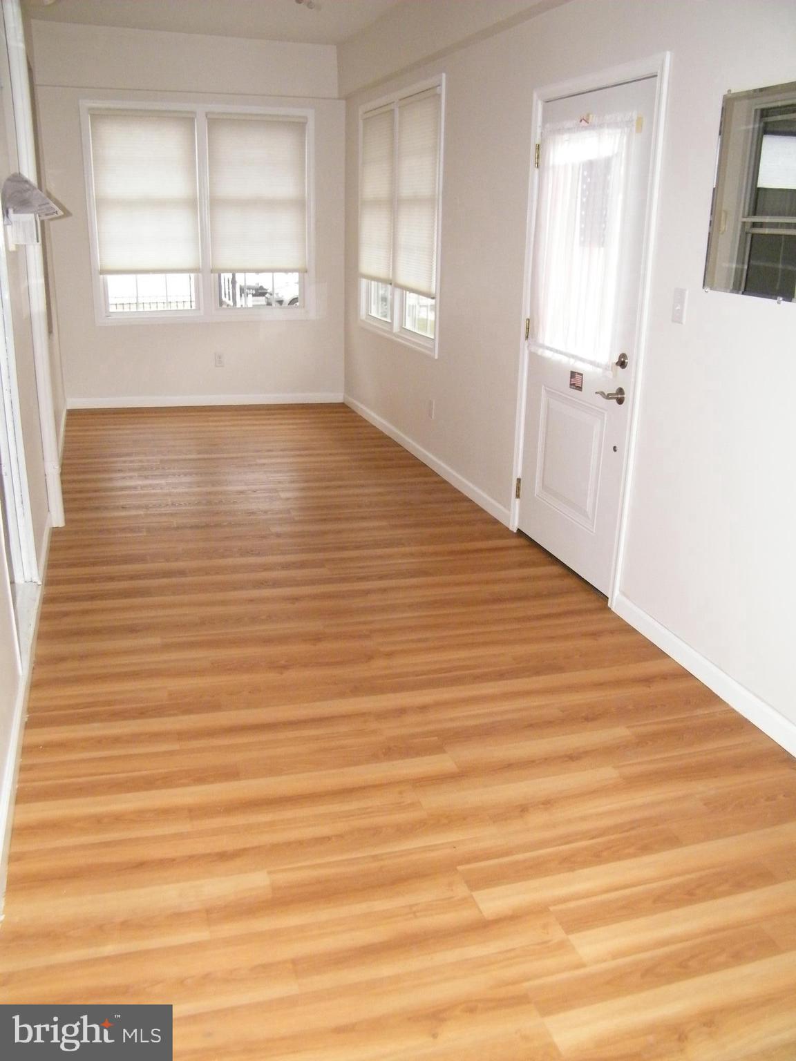 7602 Old Harford Road Parkville, MD 21234 - Photo 34 of 48 a view of an empty room with wooden floor and a window