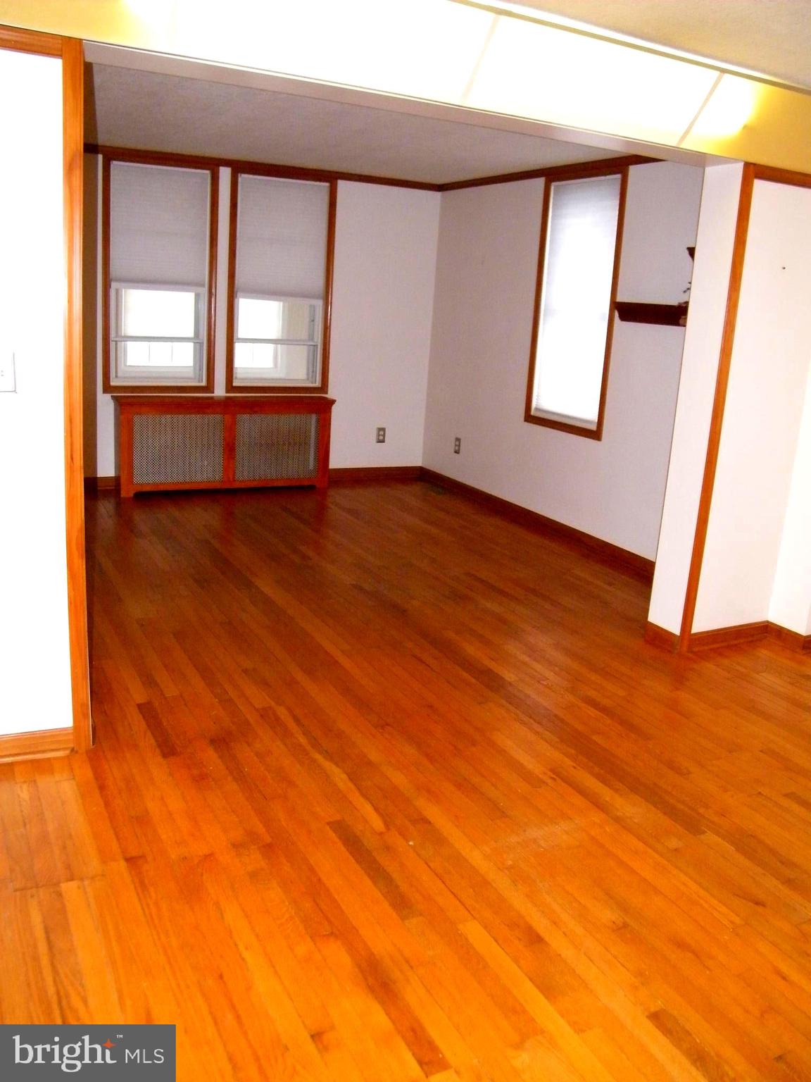 7602 Old Harford Road Parkville, MD 21234 - Photo 7 of 48 an empty room with wooden floor and windows