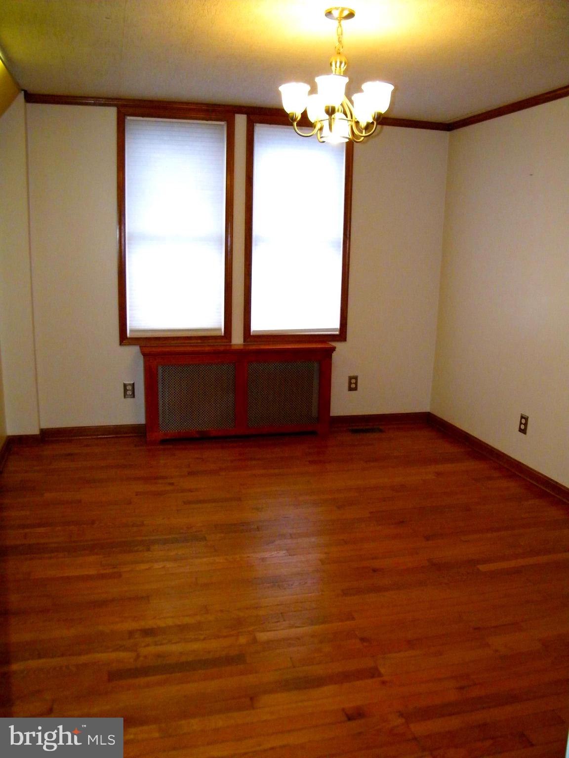7602 Old Harford Road Parkville, MD 21234 - Photo 8 of 48 an empty room with wooden floor and windows