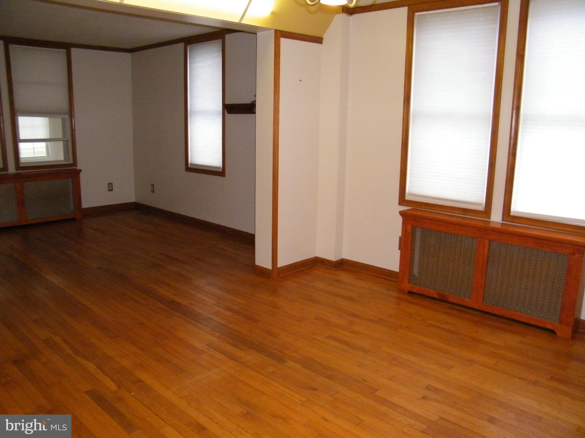 7602 Old Harford Road Parkville, MD 21234 - Photo 9 of 48 an empty room with wooden floor and windows