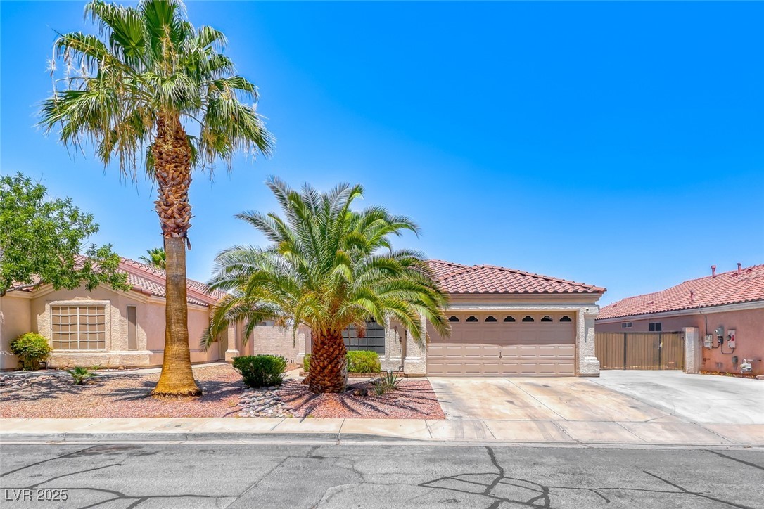 990 Ridge Path Avenue Henderson, NV 89015 - Photo 1 of 41 Mediterranean / spanish house with driveway, a garage, stucco siding, and a tiled roof