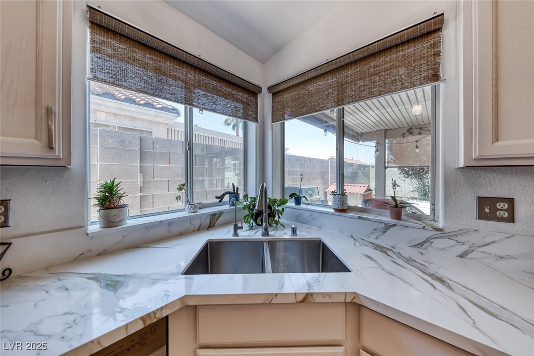 990 Ridge Path Avenue Henderson, NV 89015 - Photo 16 of 41 Kitchen featuring light stone counters and dishwasher