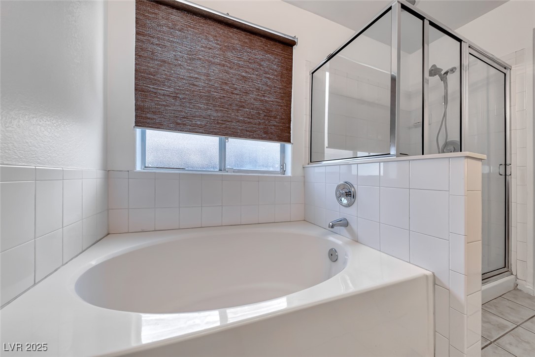 990 Ridge Path Avenue Henderson, NV 89015 - Photo 18 of 41 Full bathroom featuring a shower stall and a garden tub