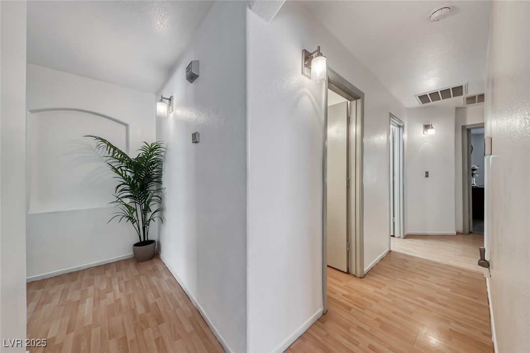 990 Ridge Path Avenue Henderson, NV 89015 - Photo 25 of 41 Hall with light wood finished floors and baseboards