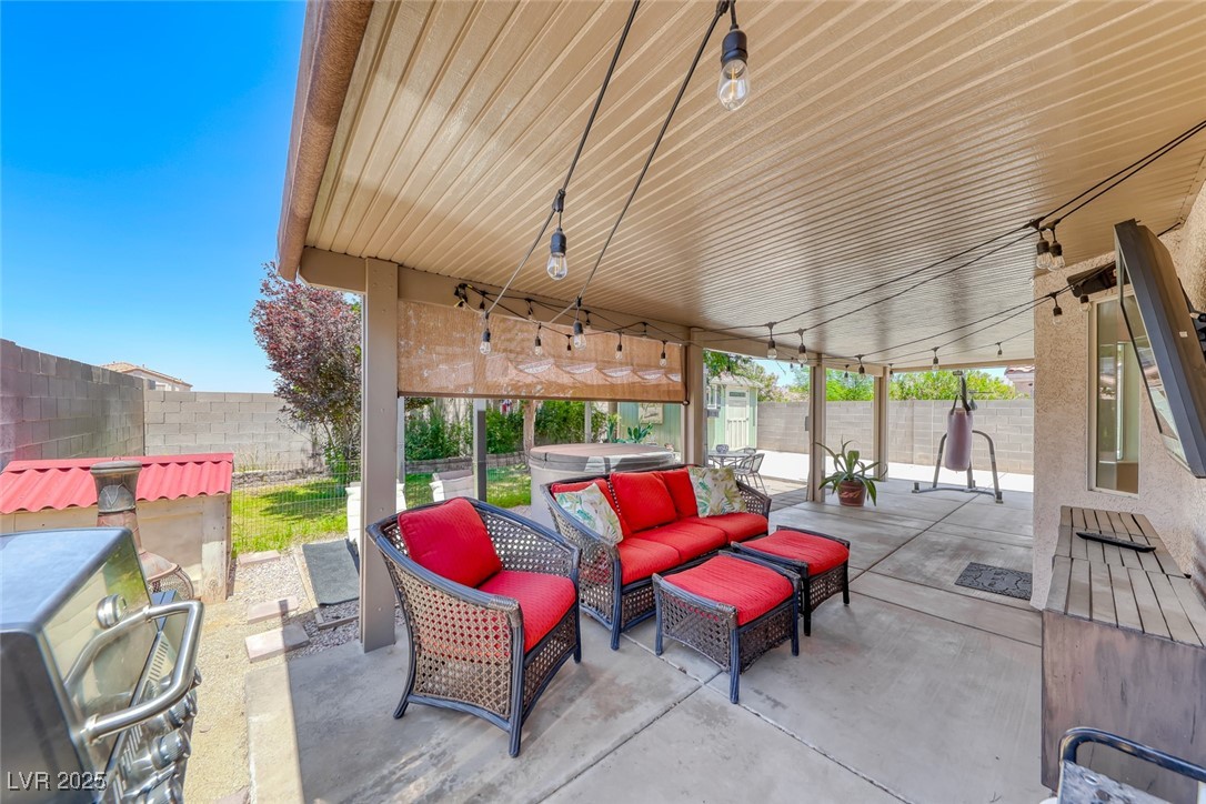 990 Ridge Path Avenue Henderson, NV 89015 - Photo 26 of 41 Fenced backyard with a hot tub, a patio area, and an outdoor hangout area