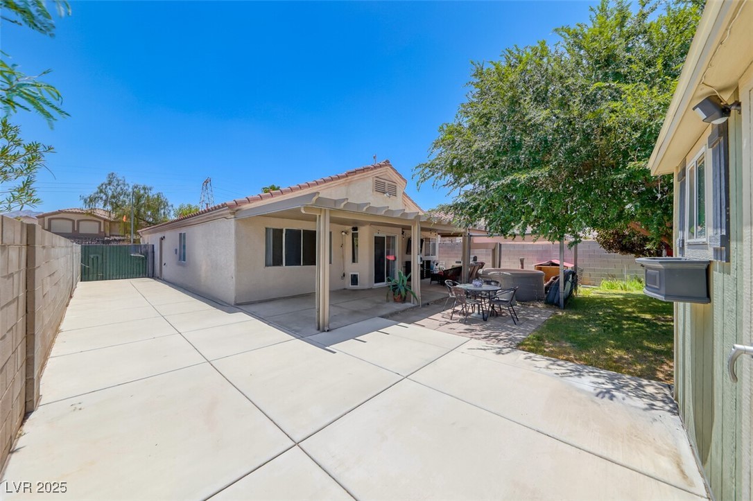 990 Ridge Path Avenue Henderson, NV 89015 - Photo 32 of 41 Rear view of house with a patio area, a fenced backyard, stucco siding, and a tiled roof