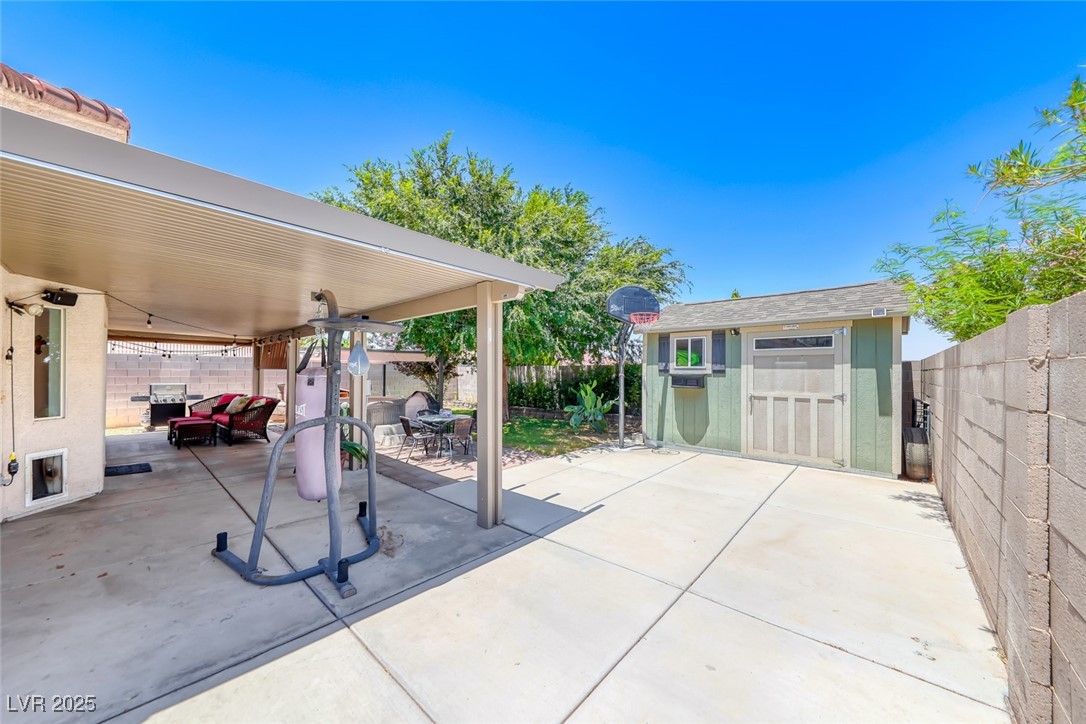 990 Ridge Path Avenue Henderson, NV 89015 - Photo 33 of 41 Fenced backyard with a patio area and a storage shed