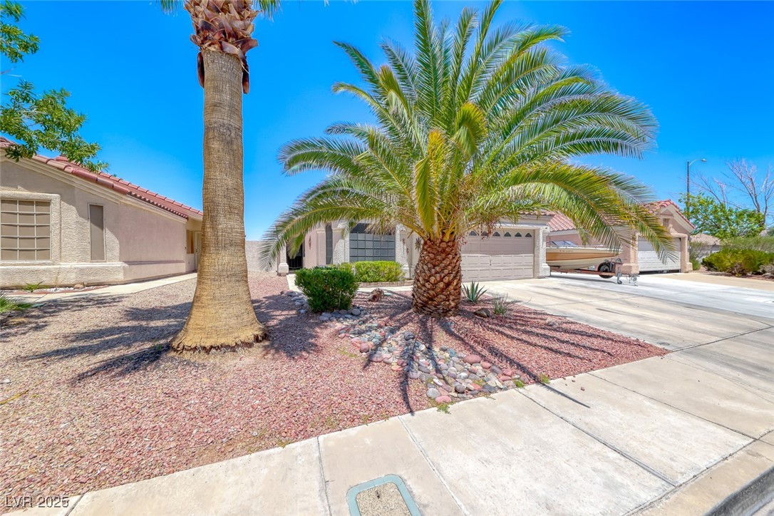 990 Ridge Path Avenue Henderson, NV 89015 - Photo 10 of 41 View of front of home featuring concrete driveway, stucco siding, and an attached garage
