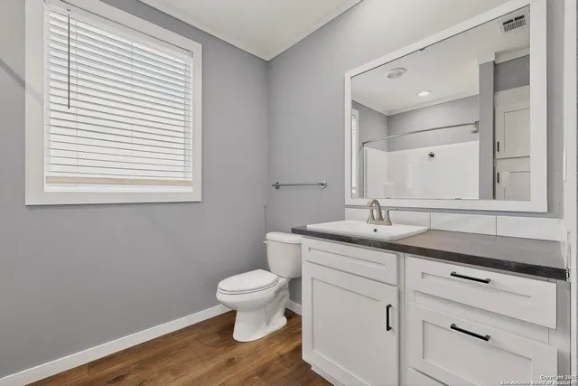 a bathroom with a toilet a sink and a mirror