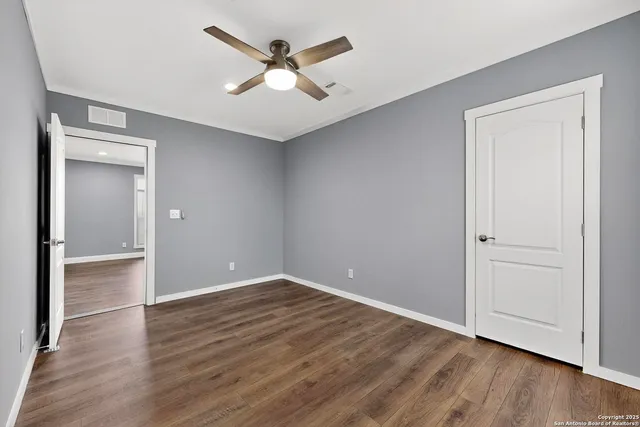 a bathroom with a granite countertop toilet a sink and a mirror