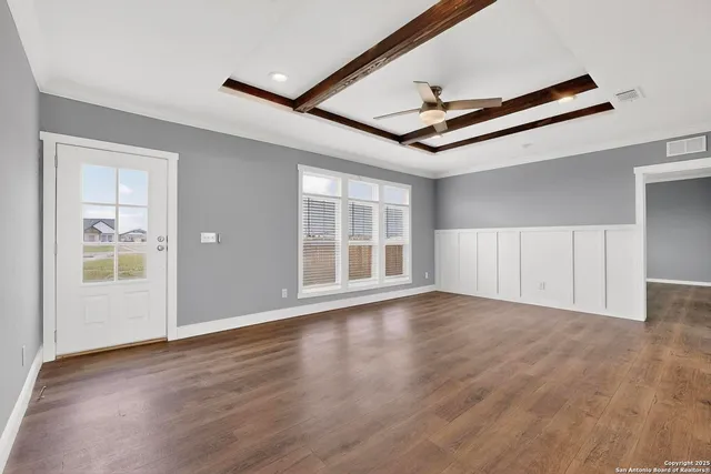 a living room with furniture a flat screen tv and a large window