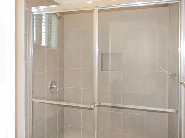 a bathroom with a glass shower door