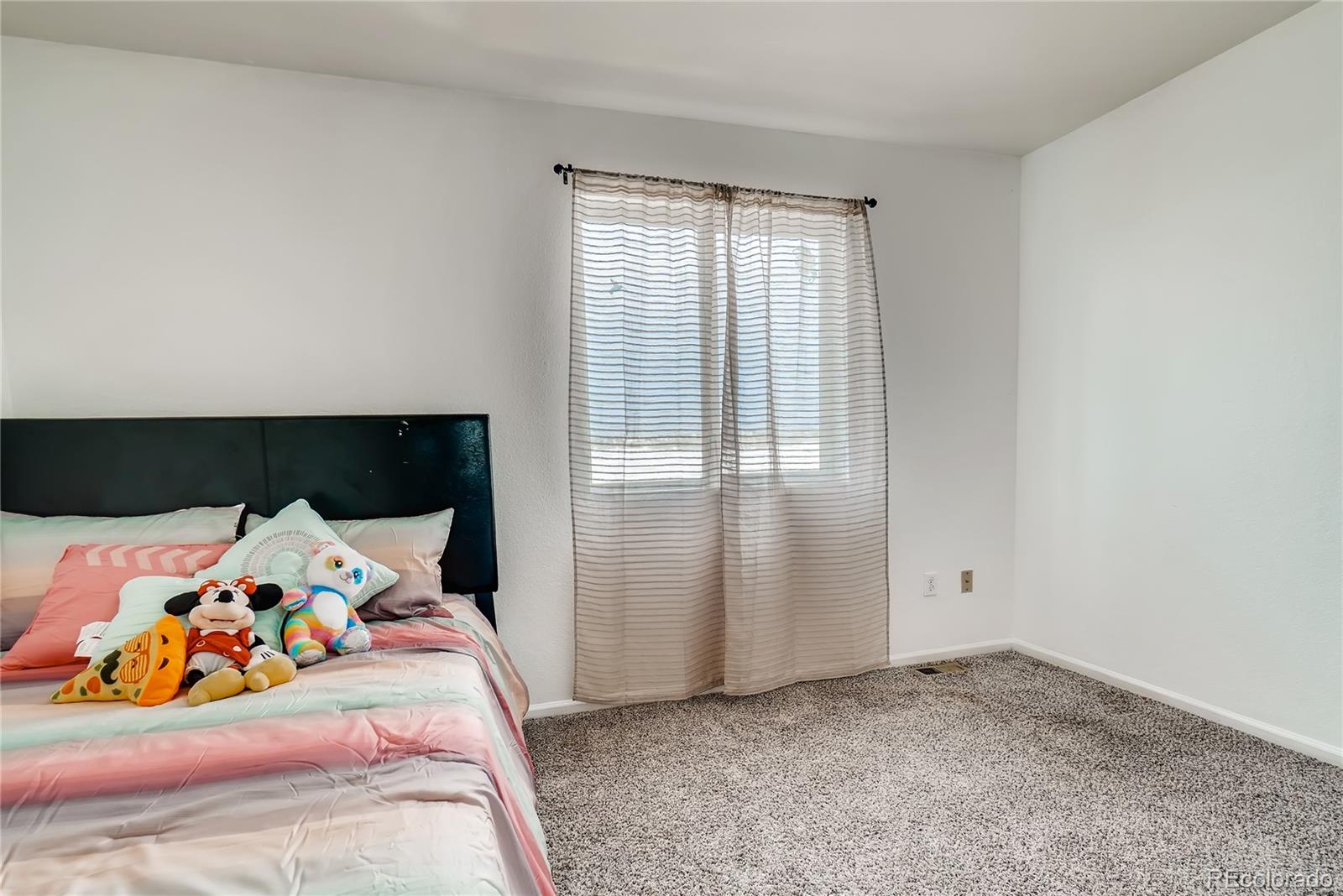 20761 Randolph Place Denver, CO 80249 - Photo 14 of 25 a bedroom with a bed and window