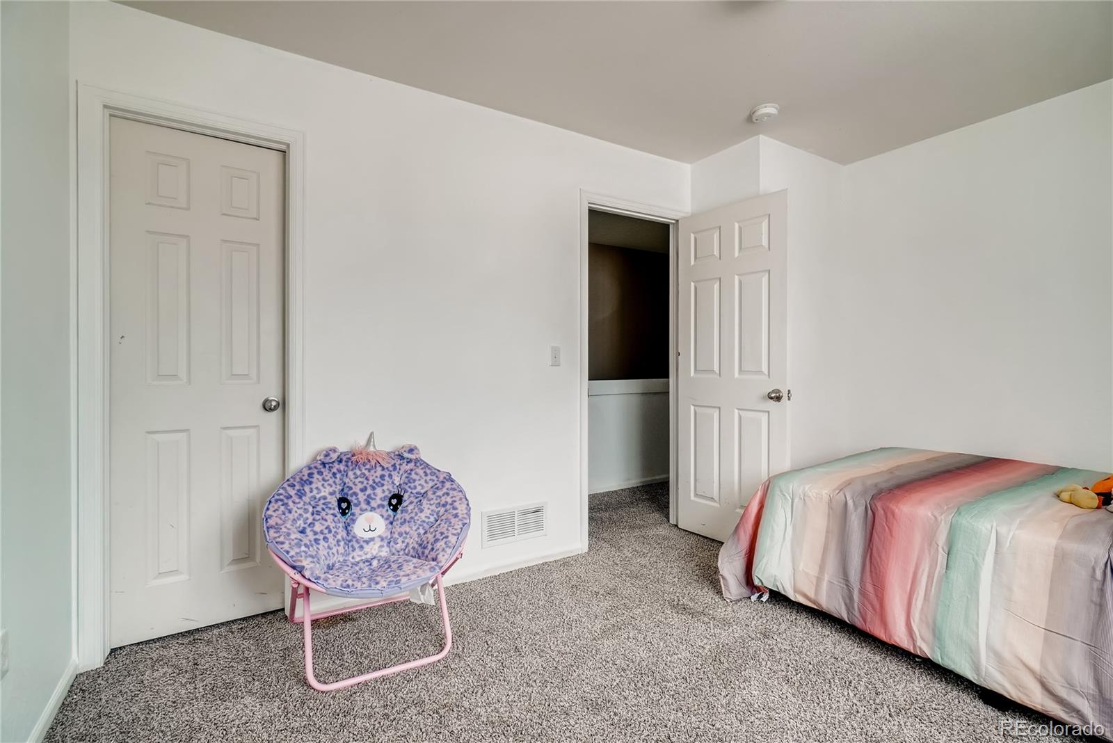 20761 Randolph Place Denver, CO 80249 - Photo 15 of 25 a bedroom with a bed and a closet