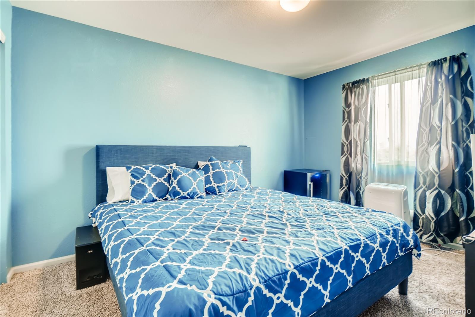 20761 Randolph Place Denver, CO 80249 - Photo 17 of 25 a bedroom with a large bed and a window