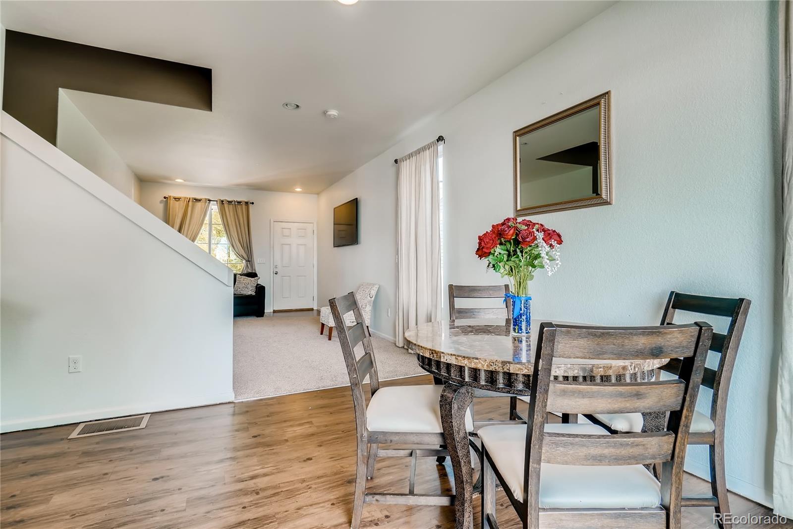 20761 Randolph Place Denver, CO 80249 - Photo 20 of 25 a view of a dining room with furniture and wooden floor