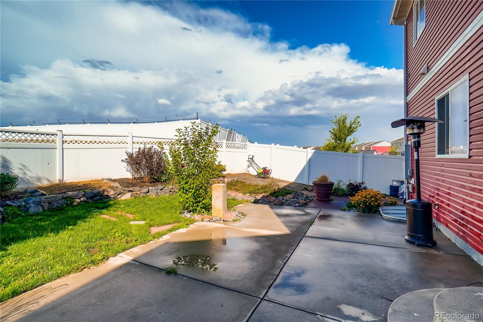 20761 Randolph Place Denver, CO 80249 - Photo 23 of 25 a view of a patio with table and chairs potted plants with wooden fence