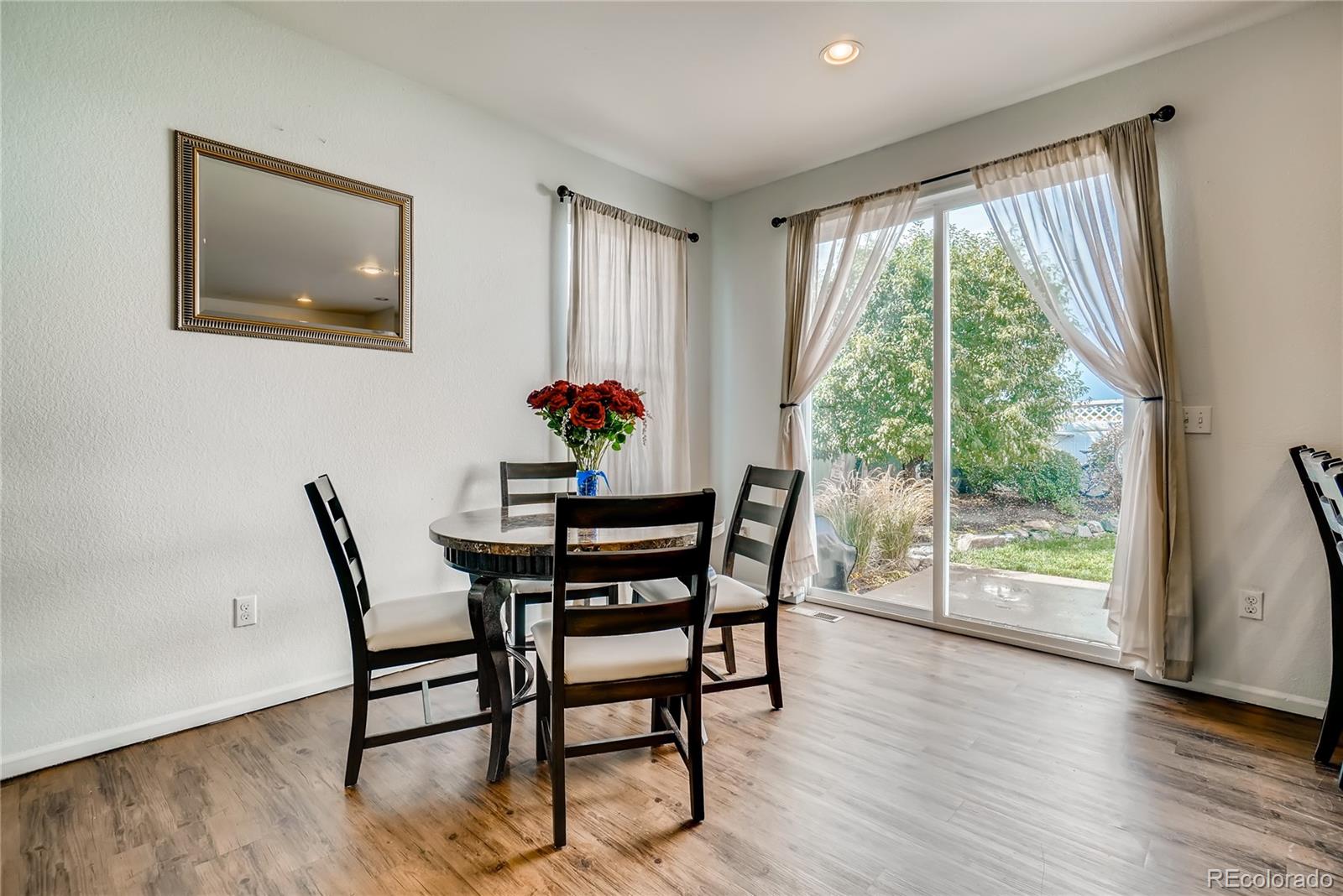 20761 Randolph Place Denver, CO 80249 - Photo 4 of 25 a dining room with furniture and wooden floor