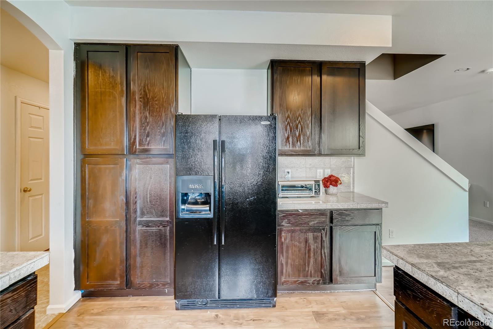 20761 Randolph Place Denver, CO 80249 - Photo 7 of 25 a kitchen with stainless steel appliances granite countertop a refrigerator and a sink