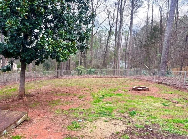 a swimming pool with outdoor seating and yard