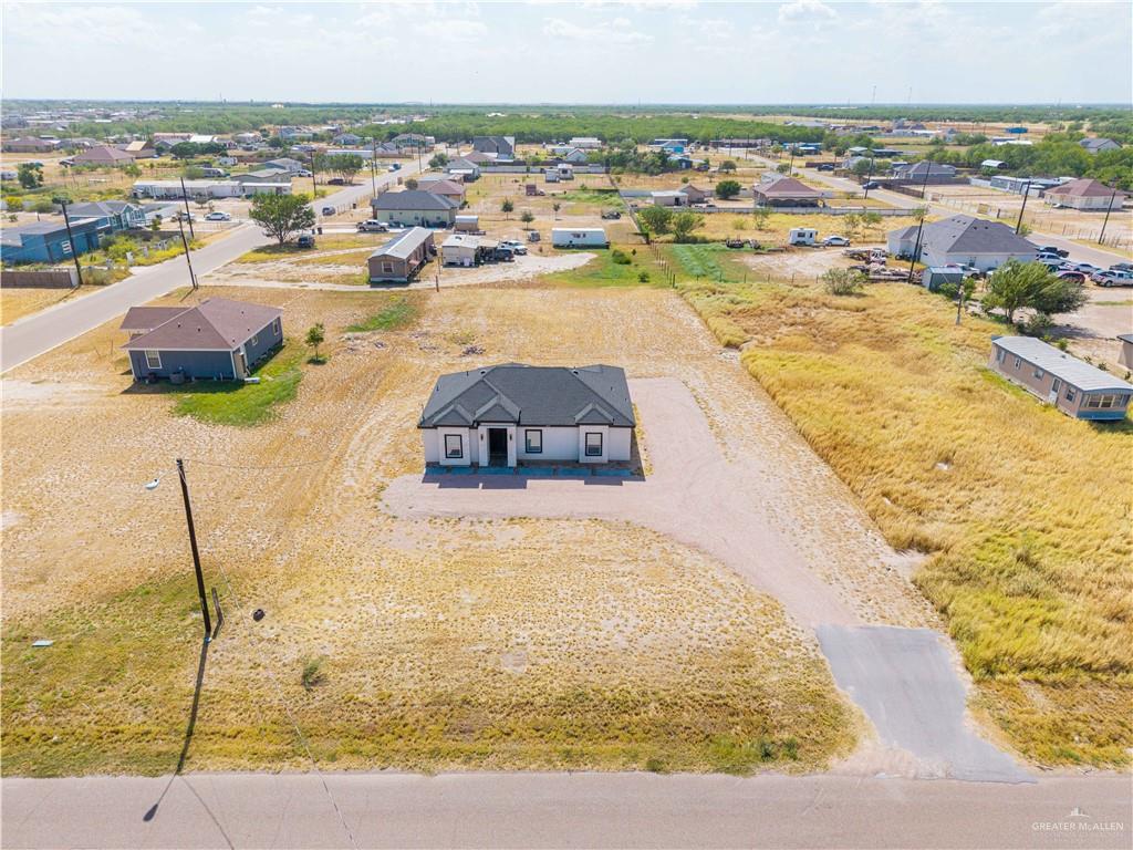 5103 Texan Road Mission, TX 78574 - Photo 14 of 17 Contemporary single-story residence with a dark-pitched roof and light-toned exterior