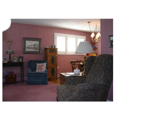 70 Proctor Road Chelmsford, MA 01824 - Photo 6 of 17 a living room with furniture and a fireplace