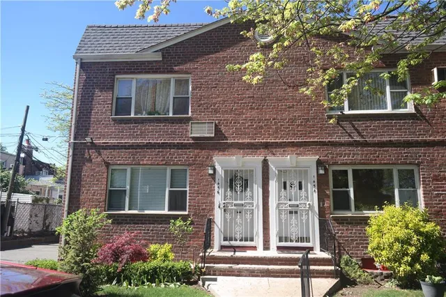 front view of a brick house with a large window