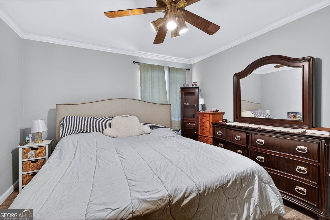 33 Warren Avenue Waverly, GA 31565 - Photo 11 of 63 a bedroom with a bed and a flat tv screen on dresser
