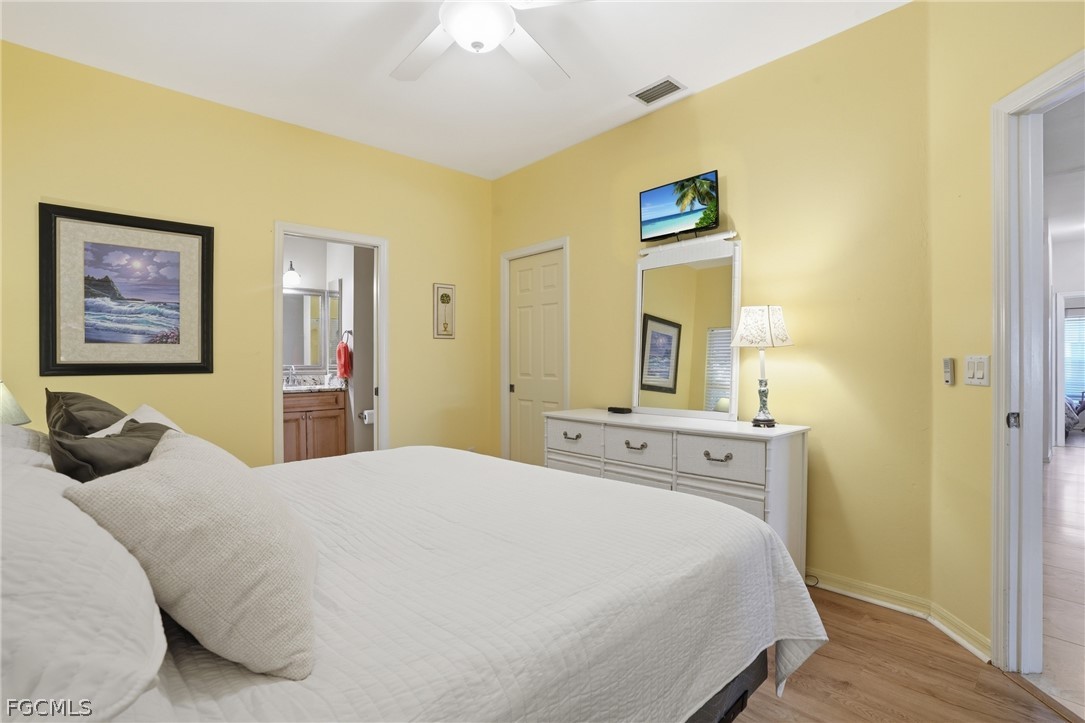 10730 Rio Mar Circle Estero, FL 33928 - Photo 16 of 47 a bedroom with a bed and a chandelier