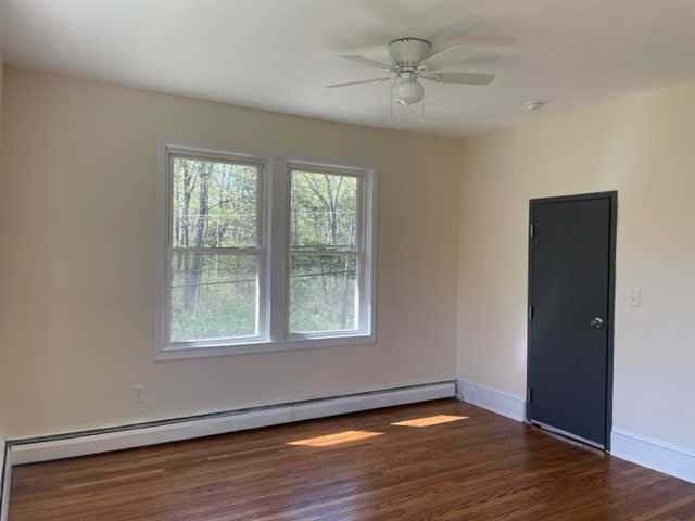 58 Wheeler Road, Unit 4 Rhinebeck, NY 12572 - Photo 2 of 6 a view of an empty room with wooden floor and a window
