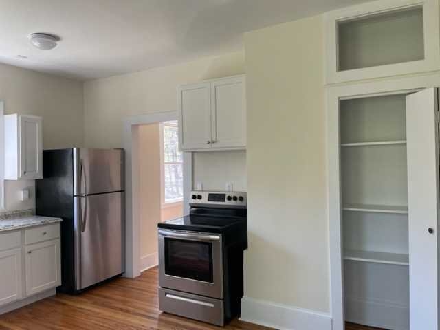 58 Wheeler Road, Unit 4 Rhinebeck, NY 12572 - Photo 4 of 6 a kitchen with a refrigerator and a stove top oven