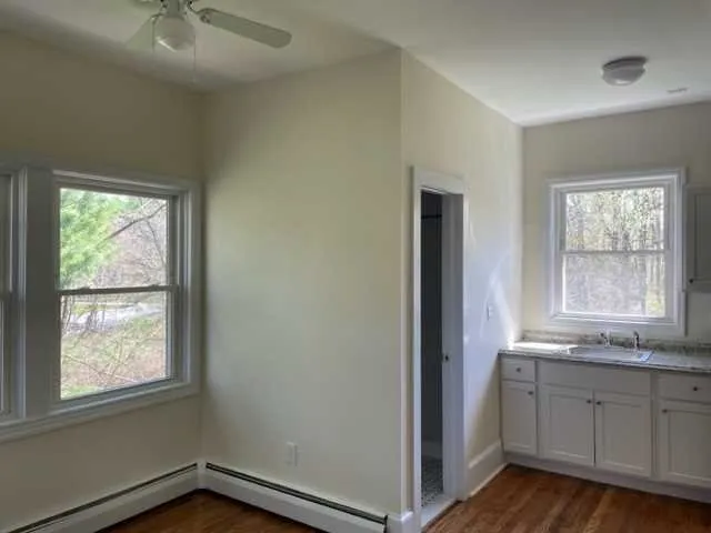 an empty room with windows and closet