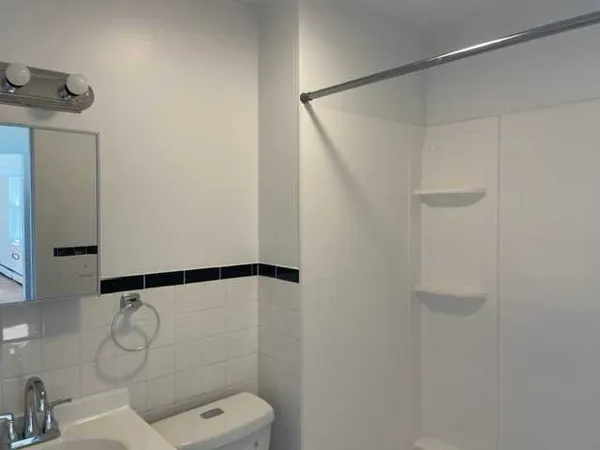 a bathroom with a toilet and a shower
