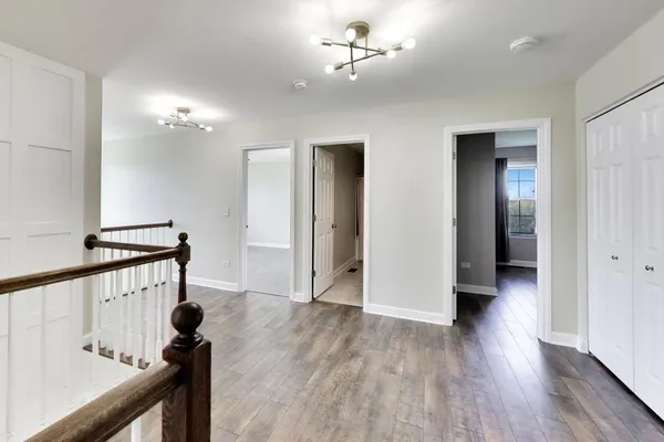 a view of a hallway view with wooden floor and staircase
