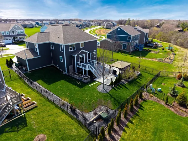 an aerial view of a house with a garden and swimming pool
