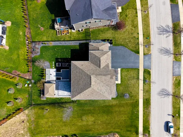 an aerial view of a house with a garden and swimming pool