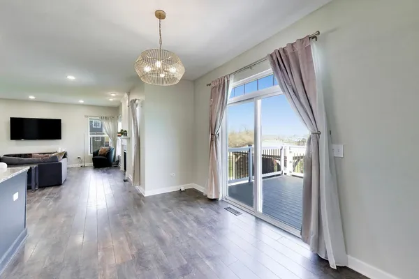 a view of a livingroom with wooden floor and furniture
