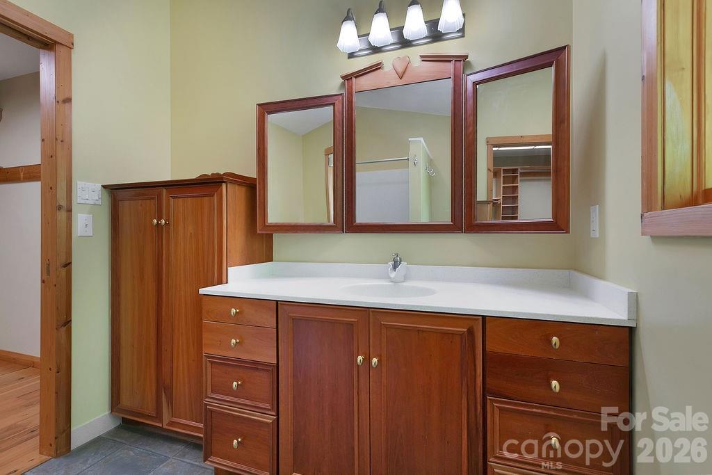 40 Walnut Ridge Road Brevard, NC 28712 - Photo 24 of 47 a bathroom with a granite countertop sink and a mirror