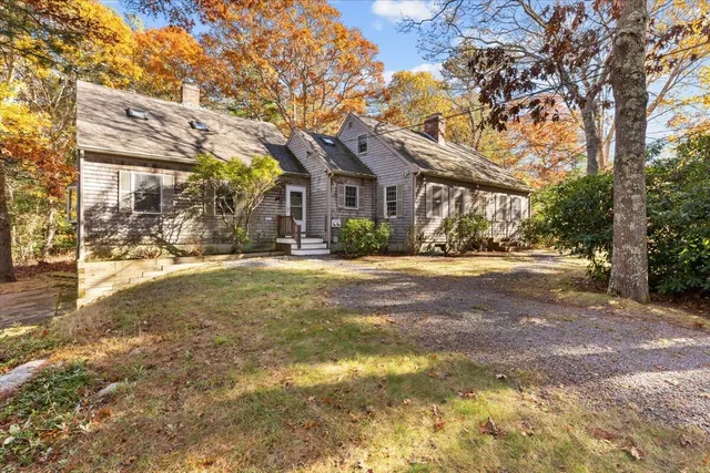 a living room with a fireplace and wooden floor