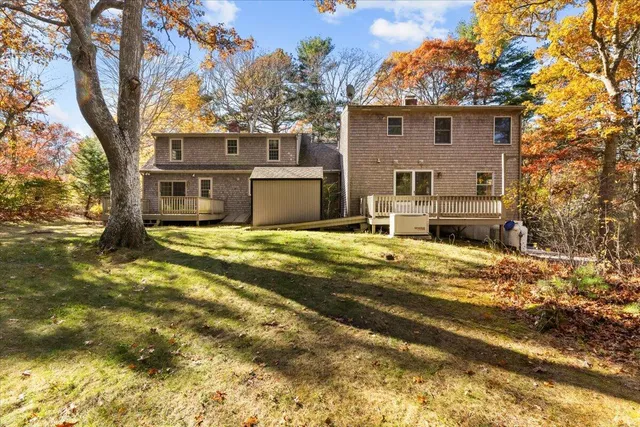 a view of an empty room with glass door and wooden floor