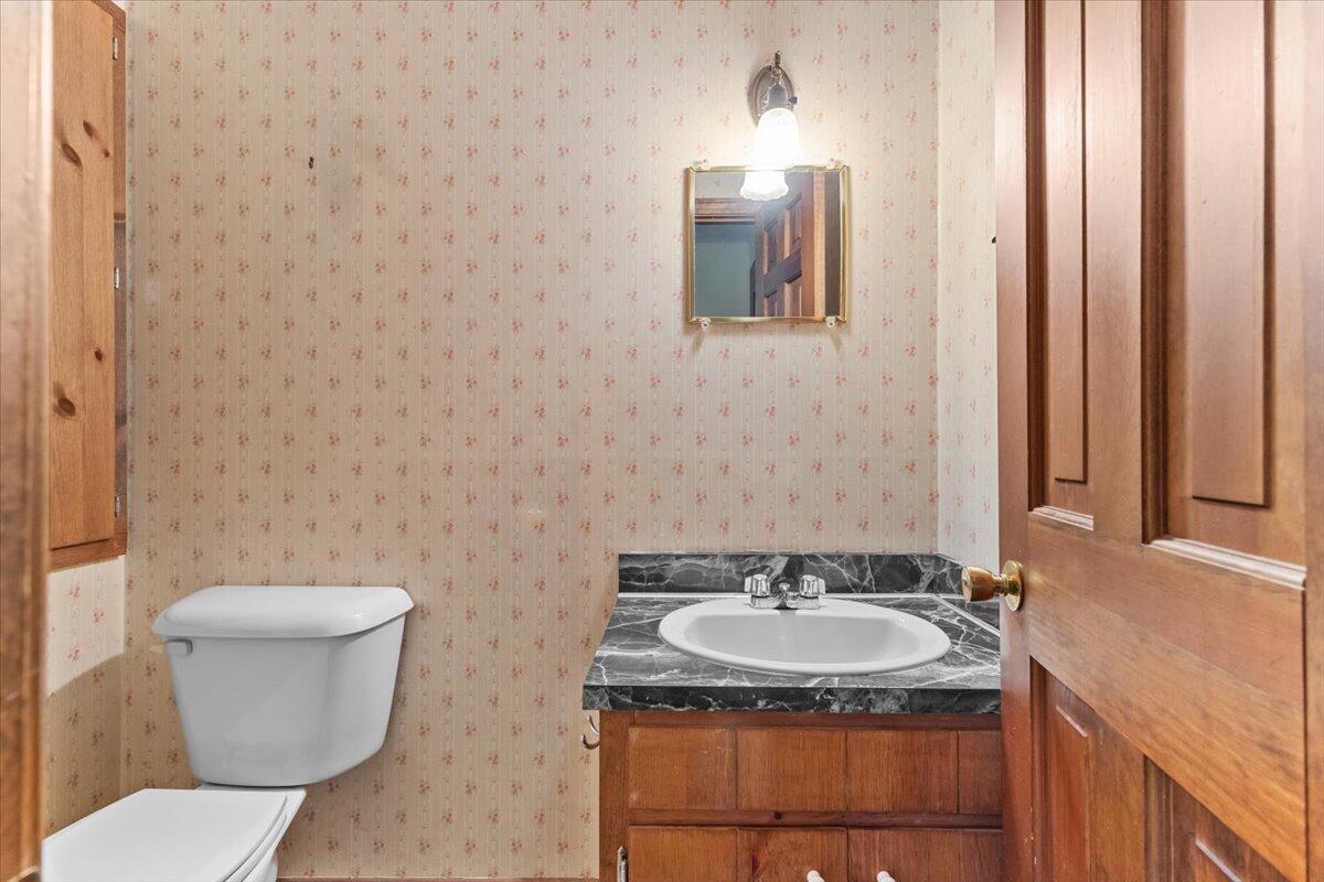 515 County Road Pocasset, MA 02559 - Photo 49 of 66 a bathroom with a granite countertop sink and a toilet