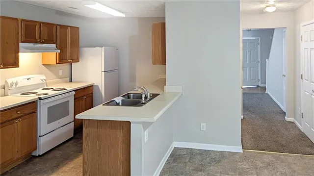 a kitchen with a sink a stove and refrigerator