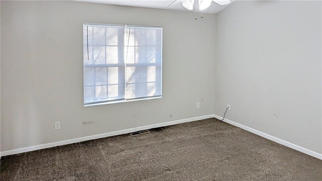 5737 Strathmoor Manor Circle Lithonia, GA 30058 - Photo 7 of 14 an empty room with a window