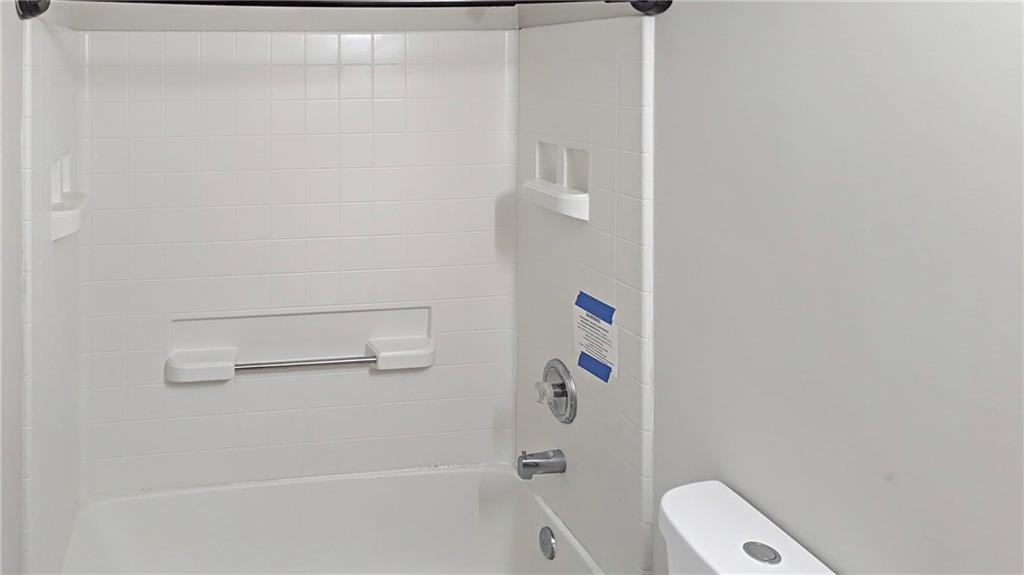 5737 Strathmoor Manor Circle Lithonia, GA 30058 - Photo 9 of 14 a bathroom with a shower and toilet