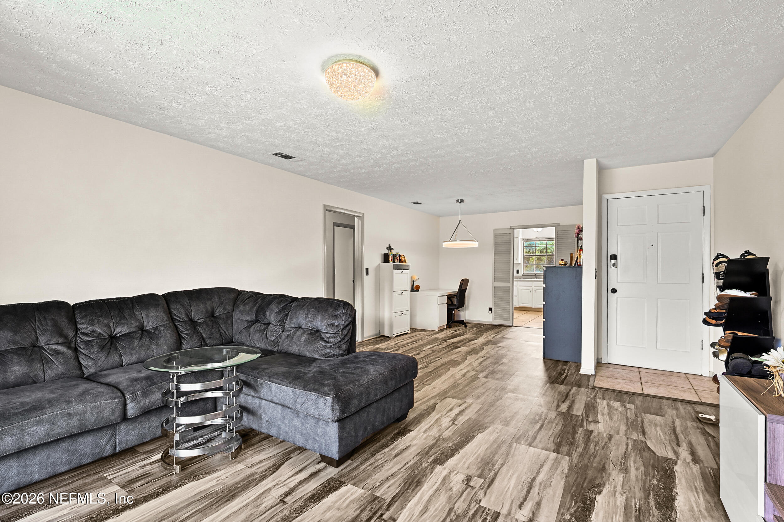 4915 Baymeadows Road, Unit 6G Jacksonville, FL 32217 - Photo 8 of 44 a living room with furniture and a wooden floor