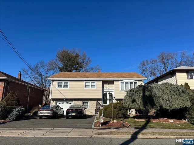 a view of a car park in front of house