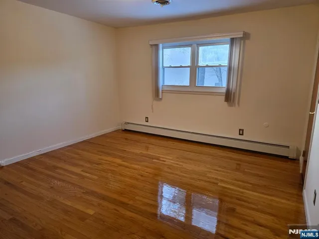 an empty room with dryer and washer