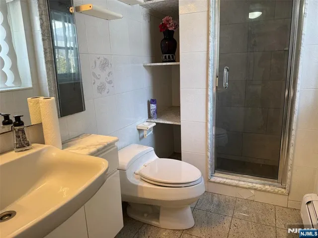 a bathroom with a toilet a sink and shower