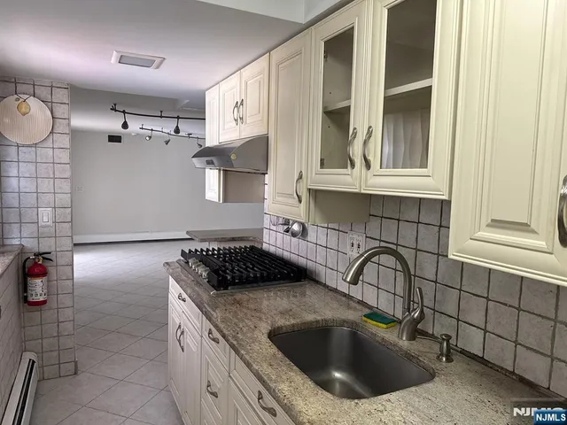 a kitchen with a sink and cabinets