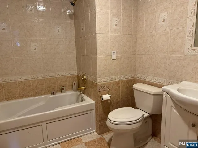a bathroom with a sink a toilet and bathtub